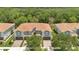 Aerial view of townhomes, showcasing a tile roof, lush landscaping, and well-manicured driveways in a serene neighborhood at 1852 Garden Sage Dr, Oviedo, FL 32765