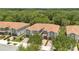 Aerial view of townhomes, showcasing a tile roof, lush landscaping, and well-manicured driveways in a serene neighborhood at 1852 Garden Sage Dr, Oviedo, FL 32765