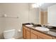 Bathroom featuring double sink vanity with granite counters and a large mirror at 1852 Garden Sage Dr, Oviedo, FL 32765