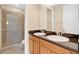 Bathroom featuring double sink vanity with granite counters and walk-in shower at 1852 Garden Sage Dr, Oviedo, FL 32765