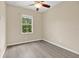 Bedroom with wood-look floors and a window overlooking lush greenery at 1852 Garden Sage Dr, Oviedo, FL 32765
