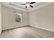 Bright bedroom featuring wood-look floors and a window with serene outdoor view at 1852 Garden Sage Dr, Oviedo, FL 32765