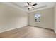 Light-filled bedroom with wood-look floors and recessed tray ceiling at 1852 Garden Sage Dr, Oviedo, FL 32765