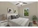 Bright bedroom featuring neutral décor, a window offering natural light, and a comfortable bed with stylish accents at 1852 Garden Sage Dr, Oviedo, FL 32765