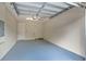 Clean garage features a painted floor, an automatic door, bright lighting, and plenty of open space for parking and storage at 1852 Garden Sage Dr, Oviedo, FL 32765
