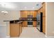 Kitchen with wood cabinets, granite countertops, stainless steel appliances, and tile flooring at 1852 Garden Sage Dr, Oviedo, FL 32765