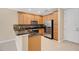 Kitchen features stainless steel appliances, wood cabinets, and granite countertops at 1852 Garden Sage Dr, Oviedo, FL 32765