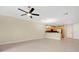 Living room with neutral walls, tile flooring, a chandelier, and a kitchen view at 1852 Garden Sage Dr, Oviedo, FL 32765