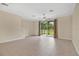 Bright living room with tile floors and sliding glass doors to screened patio at 1852 Garden Sage Dr, Oviedo, FL 32765