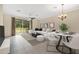 Bright living room showcasing neutral tones, modern furnishings, and seamless indoor-outdoor living through sliding glass doors at 1852 Garden Sage Dr, Oviedo, FL 32765