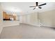 Spacious living room open to kitchen, featuring tile flooring and staircase at 1852 Garden Sage Dr, Oviedo, FL 32765