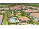 A stunning aerial view of a community pool with palm trees, a playground, and lovely landscaping, a perfect spot for relaxation at 1852 Garden Sage Dr, Oviedo, FL 32765