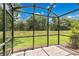 Enjoy the outdoors with this screened patio that offers a view of the green lawn and the surrounding natural landscape at 1852 Garden Sage Dr, Oviedo, FL 32765