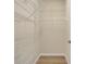 Walk-in closet with white wire shelving and wood-look floors at 1852 Garden Sage Dr, Oviedo, FL 32765