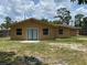 Exterior rear view of the house showcasing siding and yard with ample space for outdoor activities at 211 Valencia Rd, Debary, FL 32713