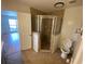 Bathroom featuring a walk-in shower, toilet, and an open door to another room at 211 Valencia Rd, Debary, FL 32713