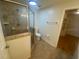 Modern bathroom with tiled shower, toilet, and view into walk-in closet at 211 Valencia Rd, Debary, FL 32713