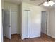 Bedroom featuring hardwood floors, a ceiling fan, and three closets at 211 Valencia Rd, Debary, FL 32713
