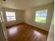 Bedroom featuring hardwood floors and two windows letting in natural light at 211 Valencia Rd, Debary, FL 32713