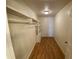 Walk in closet featuring built-in shelving units and hardwood floors at 211 Valencia Rd, Debary, FL 32713