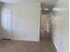 Hallway showing tile flooring, white trim and a door, with other rooms visible in the background at 211 Valencia Rd, Debary, FL 32713