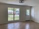 Bright living room featuring neutral walls, tile floors, a large window and stylish light fixture at 211 Valencia Rd, Debary, FL 32713