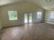 Cozy bonus room with vaulted ceiling, built in shelves, tile floors, and backyard access at 211 Valencia Rd, Debary, FL 32713