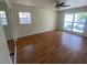 Laminate flooring with two windows and a ceiling fan at 211 Valencia Rd, Debary, FL 32713