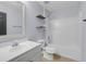 Well-lit bathroom featuring a tub with shower and modern vanity at 2255 Tealwood Cir, Tavares, FL 32778