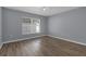 Light and bright bedroom with a ceiling fan, window with blinds, and laminate floors in a neutral color palette at 2255 Tealwood Cir, Tavares, FL 32778