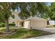 Inviting home with a two-car garage and a charming, well-manicured front yard and lawn at 2255 Tealwood Cir, Tavares, FL 32778