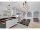 Bright eat-in kitchen features white cabinets, dark counters, island, and stainless steel appliances at 2255 Tealwood Cir, Tavares, FL 32778