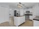 Modern kitchen features white cabinets, stainless steel appliances, and a functional center island at 2255 Tealwood Cir, Tavares, FL 32778