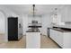 Spacious kitchen with white cabinets, stainless steel appliances, and a functional center island at 2255 Tealwood Cir, Tavares, FL 32778