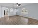 Bright and airy living room with wood flooring, arched features, and natural light at 2255 Tealwood Cir, Tavares, FL 32778
