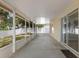 Enclosed patio with a concrete floor, screened windows for ventilation and natural light, and a view of the backyard at 2255 Tealwood Cir, Tavares, FL 32778