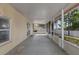 Enclosed patio with a concrete floor, screened windows for ventilation and natural light, and a view of the backyard at 2255 Tealwood Cir, Tavares, FL 32778