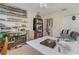 Bedroom features display shelves, a ceiling fan, and neutral color palette at 2283 Knollwood Dr, Leesburg, FL 34748