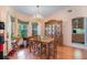 Bright dining room features hardwood floors, chandelier, and wooden china cabinet at 2283 Knollwood Dr, Leesburg, FL 34748