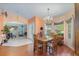 Bright dining room featuring hardwood floors, chandelier, and views to living areas at 2283 Knollwood Dr, Leesburg, FL 34748