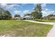 Single story home featuring mature trees, a large front yard, and a long driveway at 2283 Knollwood Dr, Leesburg, FL 34748
