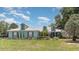Charming home with a beautifully landscaped front yard and a well-manicured lawn at 2283 Knollwood Dr, Leesburg, FL 34748