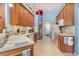 Spacious kitchen features white appliances, wood cabinets, and tiled flooring at 2283 Knollwood Dr, Leesburg, FL 34748