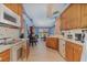 Bright kitchen features white appliances, wood cabinets, and adjacent dining area at 2283 Knollwood Dr, Leesburg, FL 34748