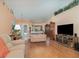 Spacious living room with hardwood floors, high ceilings, and ample natural light at 2283 Knollwood Dr, Leesburg, FL 34748