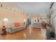 Bright living room with hardwood floors and open floor plan leads to dining area at 2283 Knollwood Dr, Leesburg, FL 34748
