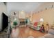 Comfortable living room with a brick fireplace, hardwood floors, and ample seating at 2283 Knollwood Dr, Leesburg, FL 34748