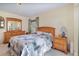 Bedroom featuring a large bed, dual nightstands, and decorative mirror at 2283 Knollwood Dr, Leesburg, FL 34748