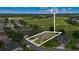 Stunning aerial view of a home with well-manicured landscaping bordering a lush green golf course at 23538 Valderama Ln, Sorrento, FL 32776