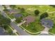 Aerial view of a well-maintained home with lush landscaping and a picturesque golf course in the background at 23538 Valderama Ln, Sorrento, FL 32776